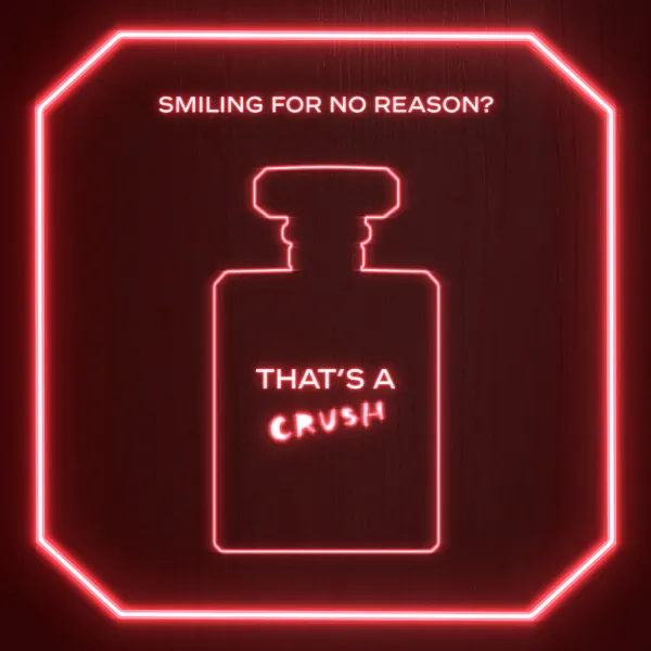 Generating response  Copilot said:  Neona stilā attēlota smaržu pudelīte ar tekstu “SMILING FOR NO REASON? THAT’S A CRUSH” uz tumši sarkana fona, ko ieskauj spilgti rozā neona rāmis.